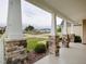 Covered porch with stone pillars overlooking a serene residential street at 63 Whistling Duck Way, Wendell, NC 27591