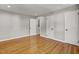 Neutral bedroom featuring beautiful hardwood floors, three white doors, baseboard trim, and recessed lighting at 6418 Beaver Creek Rd, New Hill, NC 27562