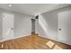 Neutrally painted bedroom with hardwood floors, baseboard trim, recessed lights, and three white doors at 6418 Beaver Creek Rd, New Hill, NC 27562