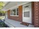 Inviting covered front porch features brick detail and a 'welcome' mat at 6418 Beaver Creek Rd, New Hill, NC 27562