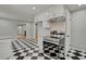 This kitchen features a checkerboard floor, modern cabinetry, stainless appliances, and an inviting layout at 6418 Beaver Creek Rd, New Hill, NC 27562