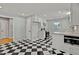 Modern kitchen with black and white checkerboard floors and stainless steel appliances at 6418 Beaver Creek Rd, New Hill, NC 27562