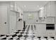Renovated kitchen featuring checkerboard floors, stainless appliances, and ample counter space at 6418 Beaver Creek Rd, New Hill, NC 27562