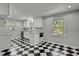 Bright, updated kitchen with stainless steel appliances and checkerboard flooring at 6418 Beaver Creek Rd, New Hill, NC 27562
