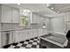 Inviting kitchen boasts stainless steel appliances, sleek countertops, and checkerboard flooring at 6418 Beaver Creek Rd, New Hill, NC 27562