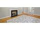 The living room features a charming fireplace, hardwood floors, and a stylish area rug at 6418 Beaver Creek Rd, New Hill, NC 27562