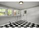 Bright mud room featuring a black and white checkered floor, bright walls, and multiple windows bringing in natural light at 6418 Beaver Creek Rd, New Hill, NC 27562