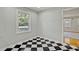 This cozy nook showcases bright window views, stylish checkerboard flooring, and a light color palette at 6418 Beaver Creek Rd, New Hill, NC 27562