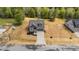 Aerial view of a grey house showcasing a long drive, front yard landscaping, and established lawn at 65 Leisure Ln # 6, Louisburg, NC 27549