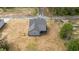 An aerial view of a newly built home with a gray roof, an adjacent paved street, and surrounding trees at 65 Leisure Ln # 6, Louisburg, NC 27549