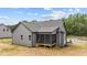 Exterior of gray home with a screened-in back porch and natural setting on a clear day at 65 Leisure Ln # 6, Louisburg, NC 27549