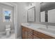 Modern bathroom with double sink vanity, white countertop, and ample natural light from a window at 65 Leisure Ln # 6, Louisburg, NC 27549
