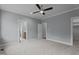 Carpeted bedroom with neutral walls, white trim, and access to an en-suite bathroom and walk-in closet at 65 Leisure Ln # 6, Louisburg, NC 27549
