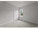Cozy bedroom with plush carpeting, a large window providing natural light, and closet at 65 Leisure Ln # 6, Louisburg, NC 27549