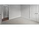 Bedroom featuring plush carpeting, access to en-suite bathroom and closet at 65 Leisure Ln # 6, Louisburg, NC 27549