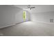 Spacious carpeted bedroom with a window overlooking a green space and a ceiling fan at 65 Leisure Ln # 6, Louisburg, NC 27549