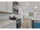 Modern kitchen with stainless steel appliances, granite countertops, and an island with a sink at 65 Leisure Ln # 6, Louisburg, NC 27549