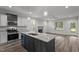 Spacious kitchen featuring stainless steel appliances, granite countertops, and an island with a sink at 65 Leisure Ln # 6, Louisburg, NC 27549