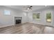 Inviting living room with a fireplace, lots of natural light, and a ceiling fan for added comfort at 65 Leisure Ln # 6, Louisburg, NC 27549