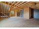 Large unfinished room with wood framing and exposed insulation features natural light from the window at 65 Leisure Ln # 6, Louisburg, NC 27549