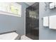 Bright bathroom featuring glass shower, and neutral wall color, as well as white tiling at 6600 Maynard Farm Rd, Chapel Hill, NC 27516