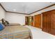 Large bedroom with twin beds, wood trim, and built-in storage at 6600 Maynard Farm Rd, Chapel Hill, NC 27516