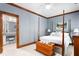 Spacious bedroom featuring a four poster bed, neutral walls, and dark wood trim and doors at 6600 Maynard Farm Rd, Chapel Hill, NC 27516