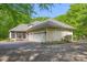Spacious three-car garage with a screened-in porch, complemented by manicured landscaping and a paved driveway at 6600 Maynard Farm Rd, Chapel Hill, NC 27516