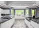 Modern kitchen featuring a gas range, granite countertops, and stylish cabinetry at 6600 Maynard Farm Rd, Chapel Hill, NC 27516