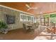 Screened porch area with seating, ceiling fans and stylish shingle exterior at 6600 Maynard Farm Rd, Chapel Hill, NC 27516