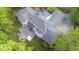 Expansive home with multiple decks and a stone fire pit in a lush, tree-filled setting, captured from above at 6600(A) Maynard Farm Rd, Chapel Hill, NC 27516