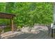 Multi-level deck with a stone fire pit and a built in grill, ideal for outdoor entertaining and relaxation at 6600(A) Maynard Farm Rd, Chapel Hill, NC 27516