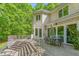 Large wooden deck accessible from the house featuring an outdoor dining and lounge area with forest views at 6600(A) Maynard Farm Rd, Chapel Hill, NC 27516