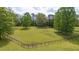 Large grassy field surrounded by mature trees and classic fencing at 6600(A) Maynard Farm Rd, Chapel Hill, NC 27516