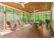 Relaxing screened porch with wood ceiling and multiple seating areas, perfect for enjoying the outdoors at 6600(A) Maynard Farm Rd, Chapel Hill, NC 27516