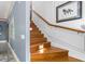 Elegant wood staircase with paneled wall, art, and ambient lighting at 6600(A) Maynard Farm Rd, Chapel Hill, NC 27516