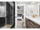 Modern bathroom boasts tiled shower, designer floor, and vanity leading to bedroom at 67 Comfort Ct, Fuquay Varina, NC 27526