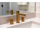 Close-up on bathroom sink featuring sleek gold fixtures, enhancing the modern aesthetic at 67 Comfort Ct, Fuquay Varina, NC 27526