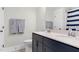 Bright bathroom features double sink vanity with dark cabinets and elegant fixtures at 67 Comfort Ct, Fuquay Varina, NC 27526