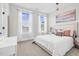 Bright bedroom showcases white bedding, large windows, and stylish decor at 67 Comfort Ct, Fuquay Varina, NC 27526
