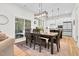 Dining room area featuring a wooden table set, modern lighting, and easy kitchen access at 67 Comfort Ct, Fuquay Varina, NC 27526