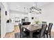 Open-concept dining room featuring stylish lighting and a spacious table at 67 Comfort Ct, Fuquay Varina, NC 27526