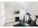 Dedicated exercise room includes fitness equipment, wall-mounted TV, and natural light at 67 Comfort Ct, Fuquay Varina, NC 27526
