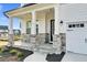 Inviting front porch with stone-covered columns and a seating area for relaxing outdoors at 67 Comfort Ct, Fuquay Varina, NC 27526
