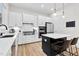 Modern kitchen with white cabinets, stainless steel appliances, and a center island at 67 Comfort Ct, Fuquay Varina, NC 27526