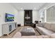 Bright living room with a modern fireplace, comfortable seating, and natural light at 67 Comfort Ct, Fuquay Varina, NC 27526
