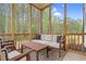 Relaxing screened porch with comfortable seating and views of the wooded backyard at 67 Comfort Ct, Fuquay Varina, NC 27526