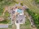 Aerial view of a landscaped home with a swimming pool in the backyard and mature trees surrounding the property at 6925 Rex Rd, Holly Springs, NC 27540