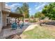 Backyard featuring a pool, deck, and lush landscaping for outdoor enjoyment and entertainment at 6925 Rex Rd, Holly Springs, NC 27540