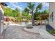 Inviting pool area with palm trees and meticulous landscaping, creating a serene and relaxing outdoor space at 6925 Rex Rd, Holly Springs, NC 27540